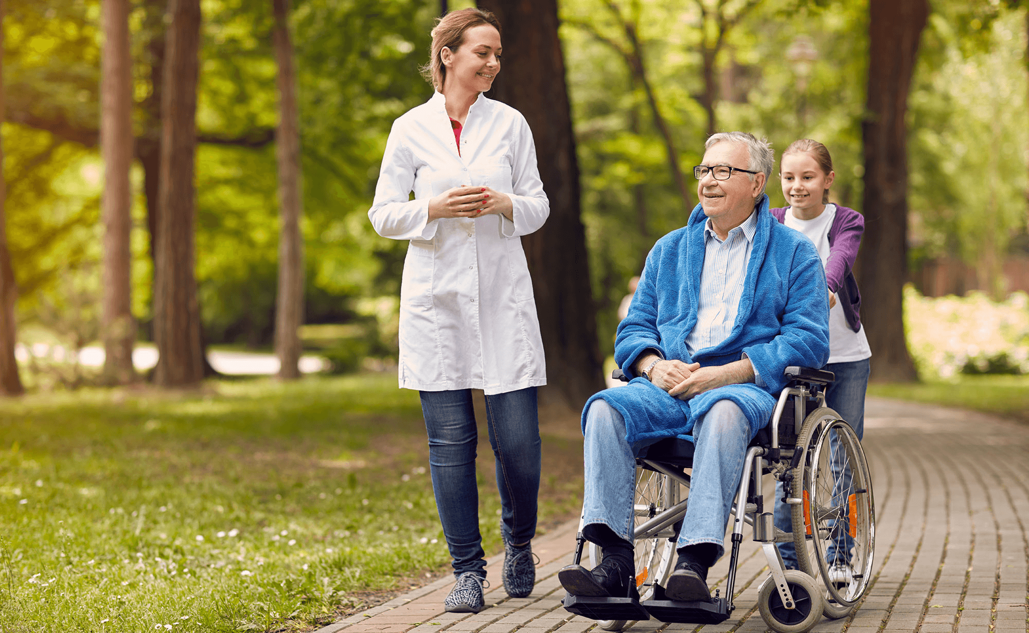 Caregiver and elderly woman sharing a warm moment outdoors