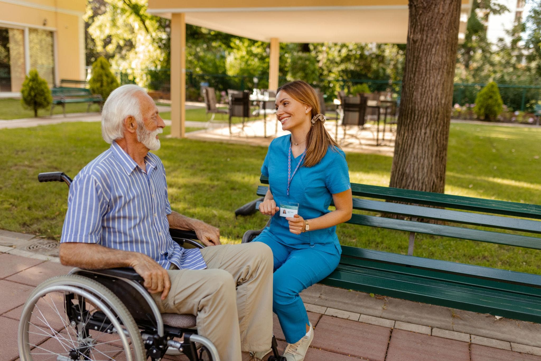 Residents enjoying time together outdoors in the care home grounds