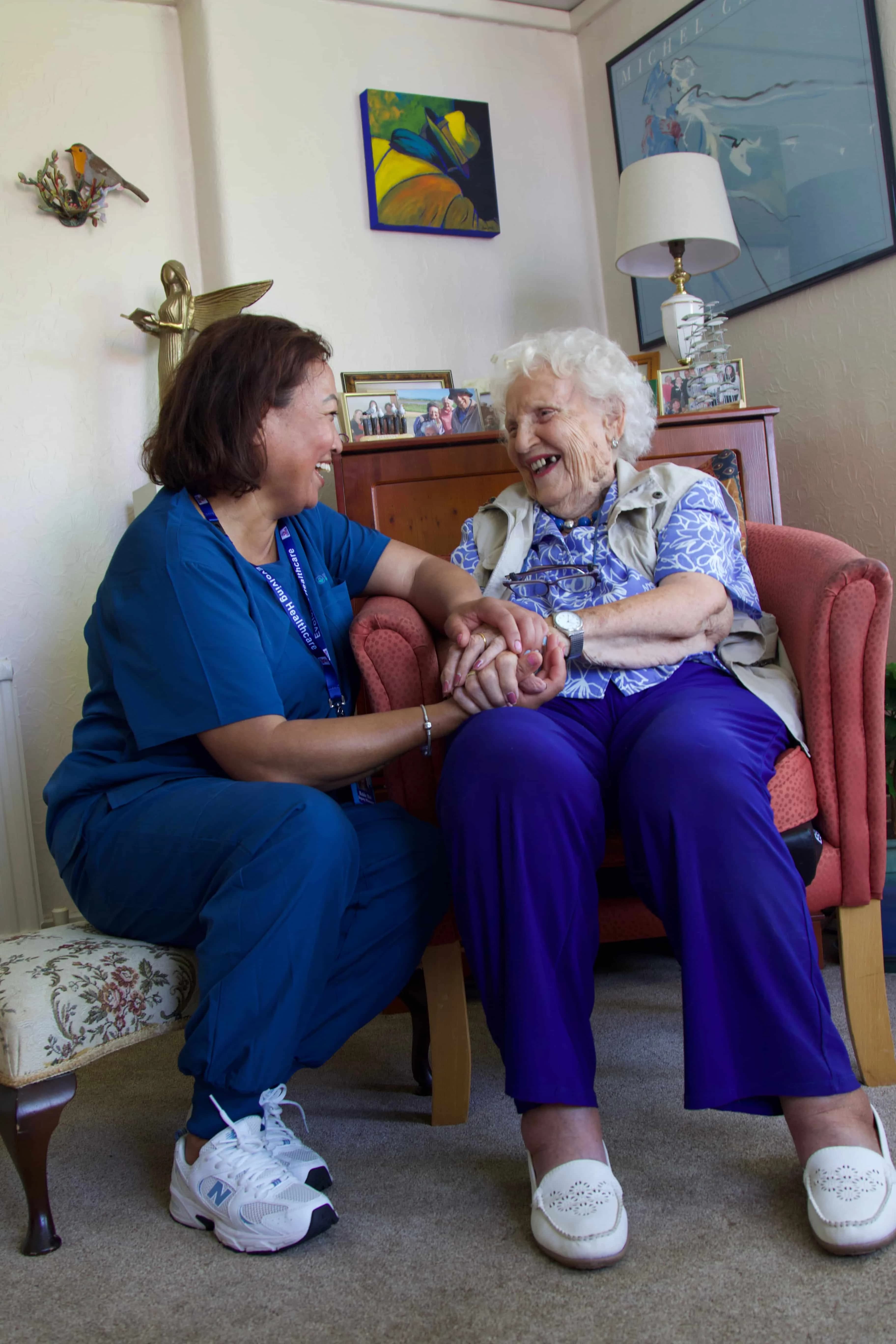 Elderly resident happy with their caregiver at home