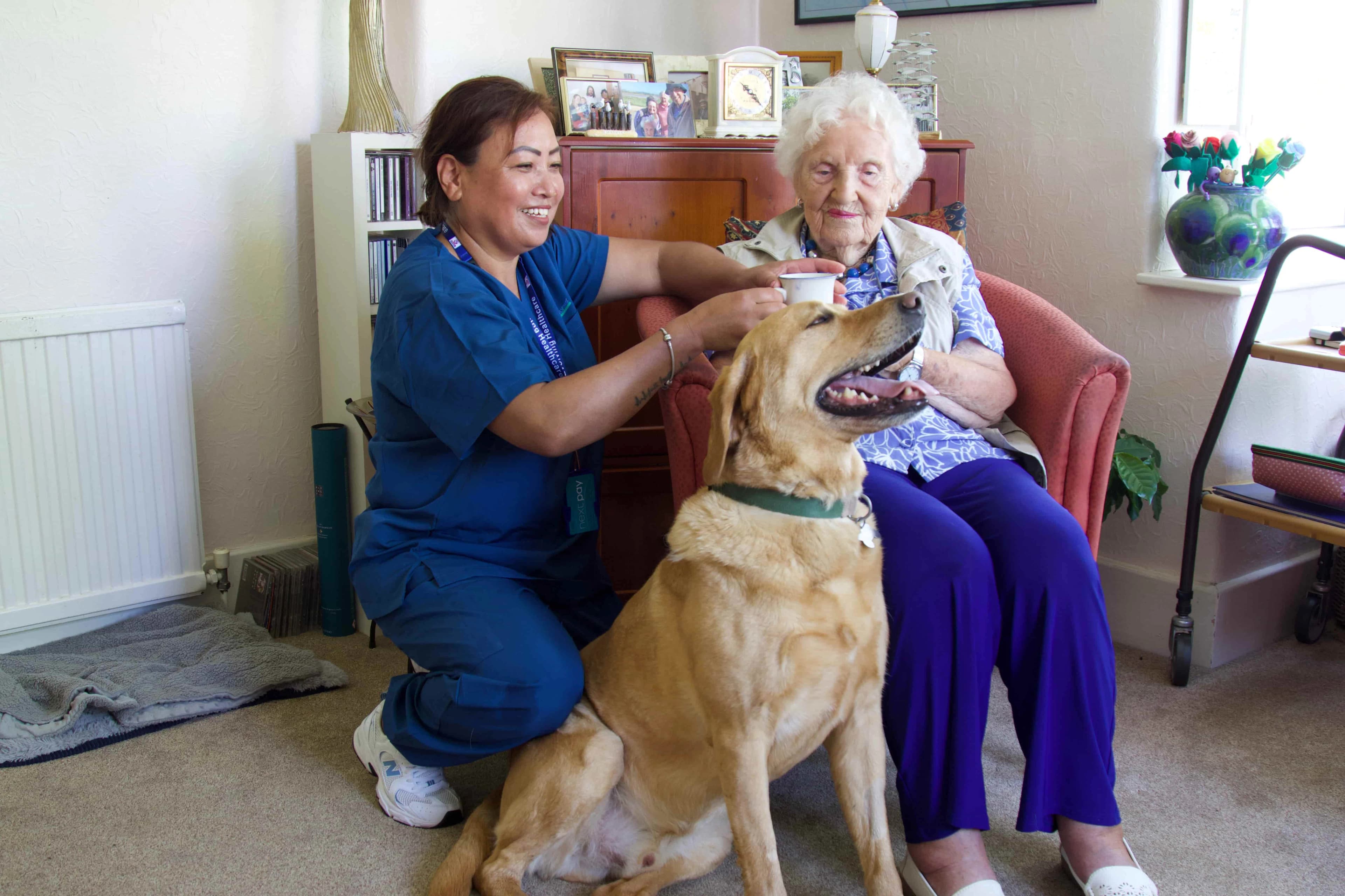 Caregiver walking outdoors with an elderly woman